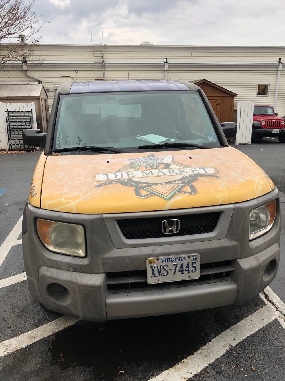 Yellow vehicle with faded custom wrap